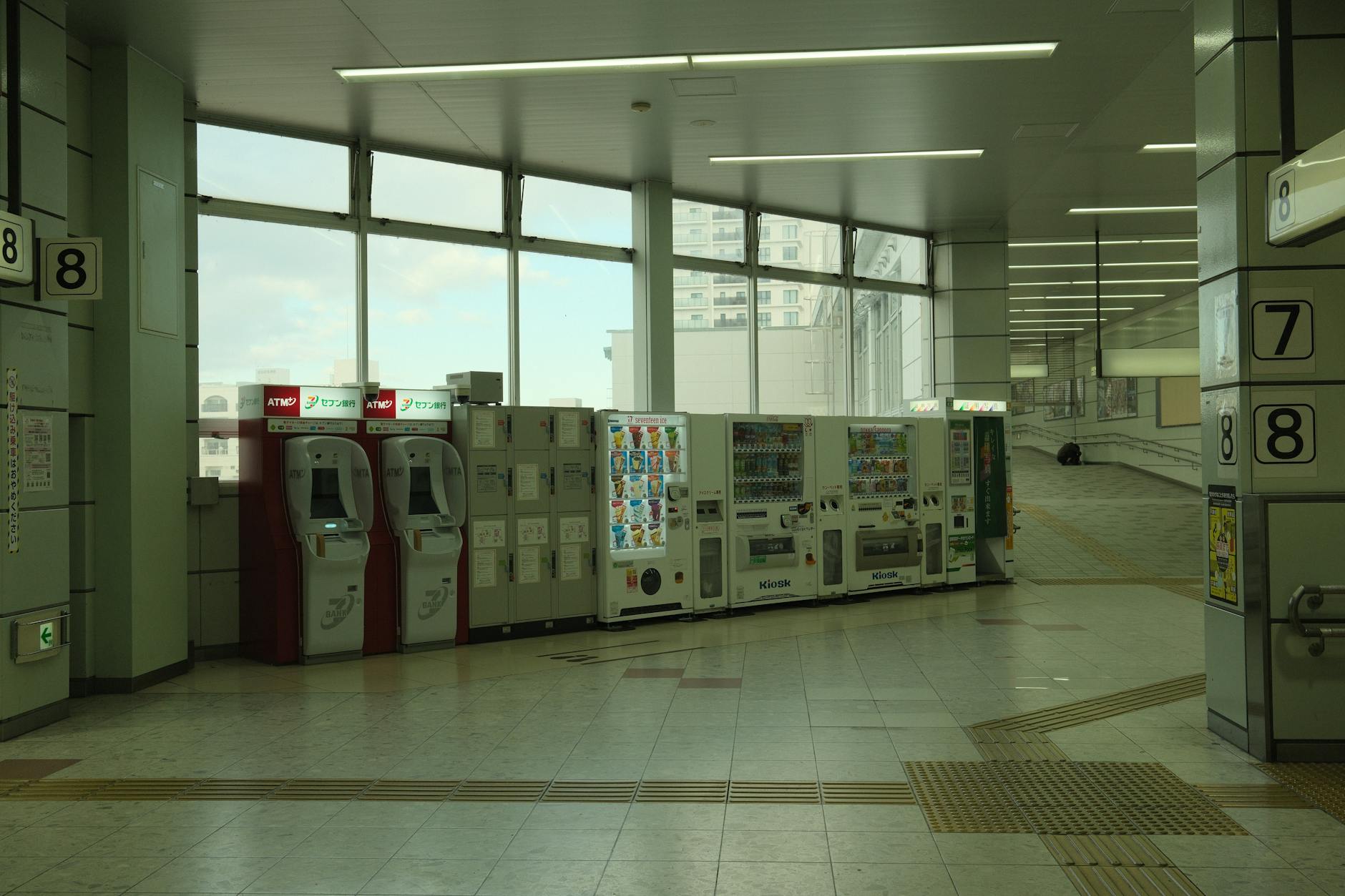 JR Pass czy bilety pojedyncze: co bardziej się opłaca w 2026? Wnętrze przestronnej stacji kolejowej w Toyohashi z automatami i bankomatami